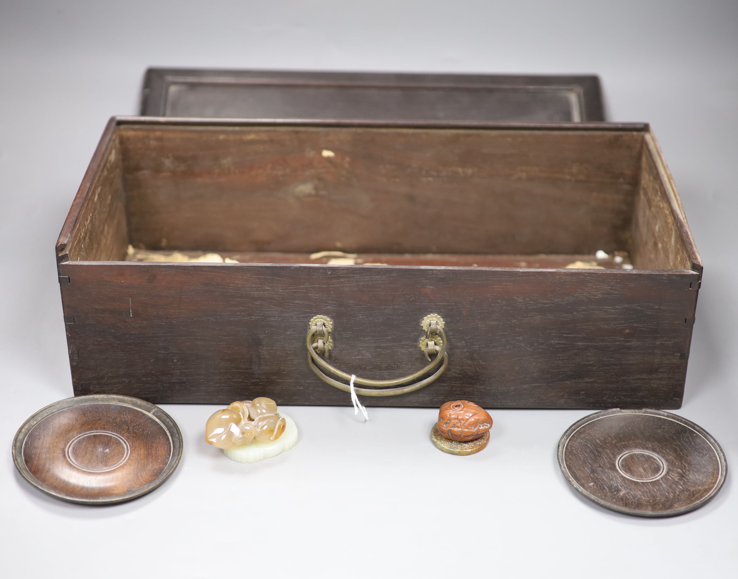 A pair of zitan wood saucers, c. 1800, a Japanese netsuke, c. 1900 an agate pendant of peaches, c.1900, a modern white jade pendant and